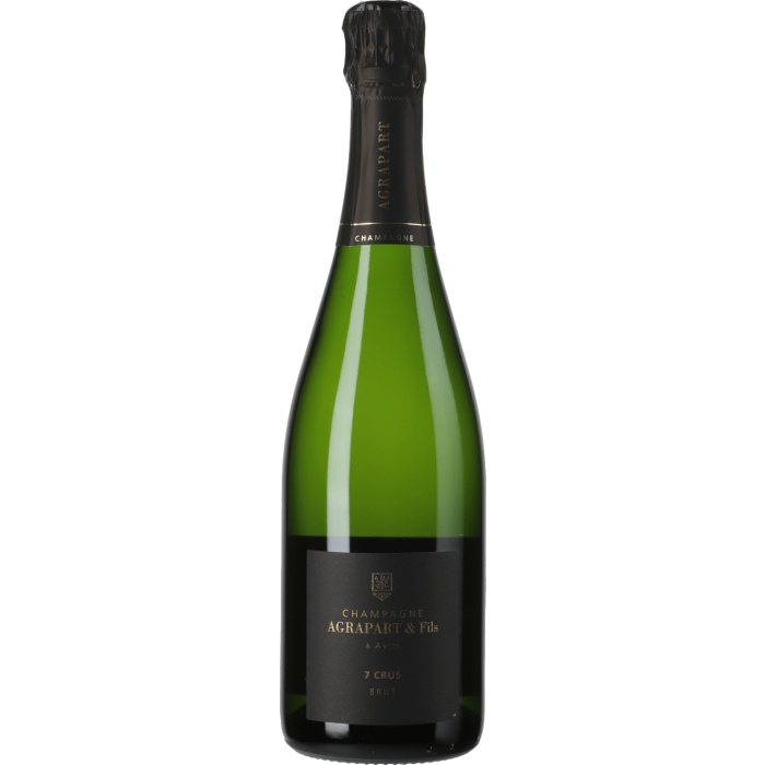 Taça de Champagne Agrapart 7 Crus, bebida espumante de alta qualidade, em taça transparente com detalhes de bolhas e coloração dourada